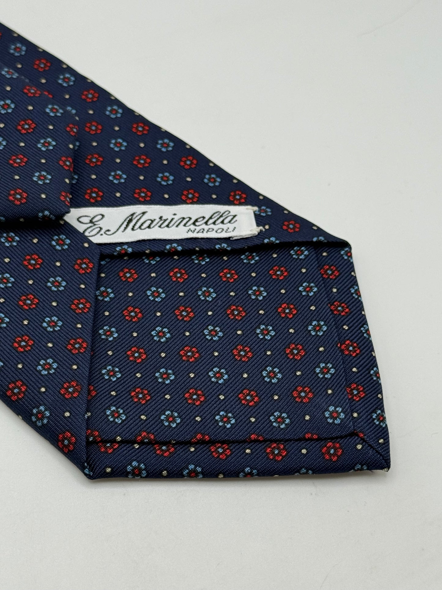 Dark blue twill silk tie whit small flower pattern