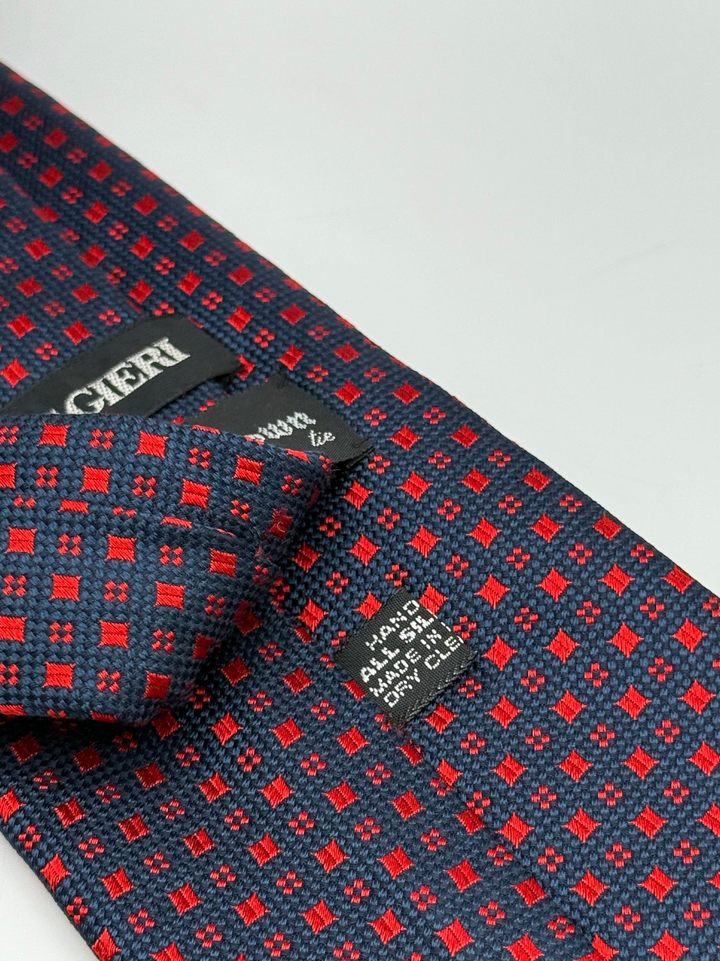 Dark blue jacquard silk tie whit small geometric pattern