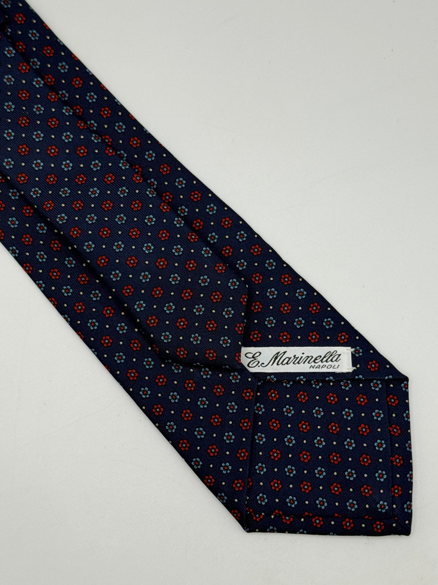 Dark blue twill silk tie whit small flower pattern