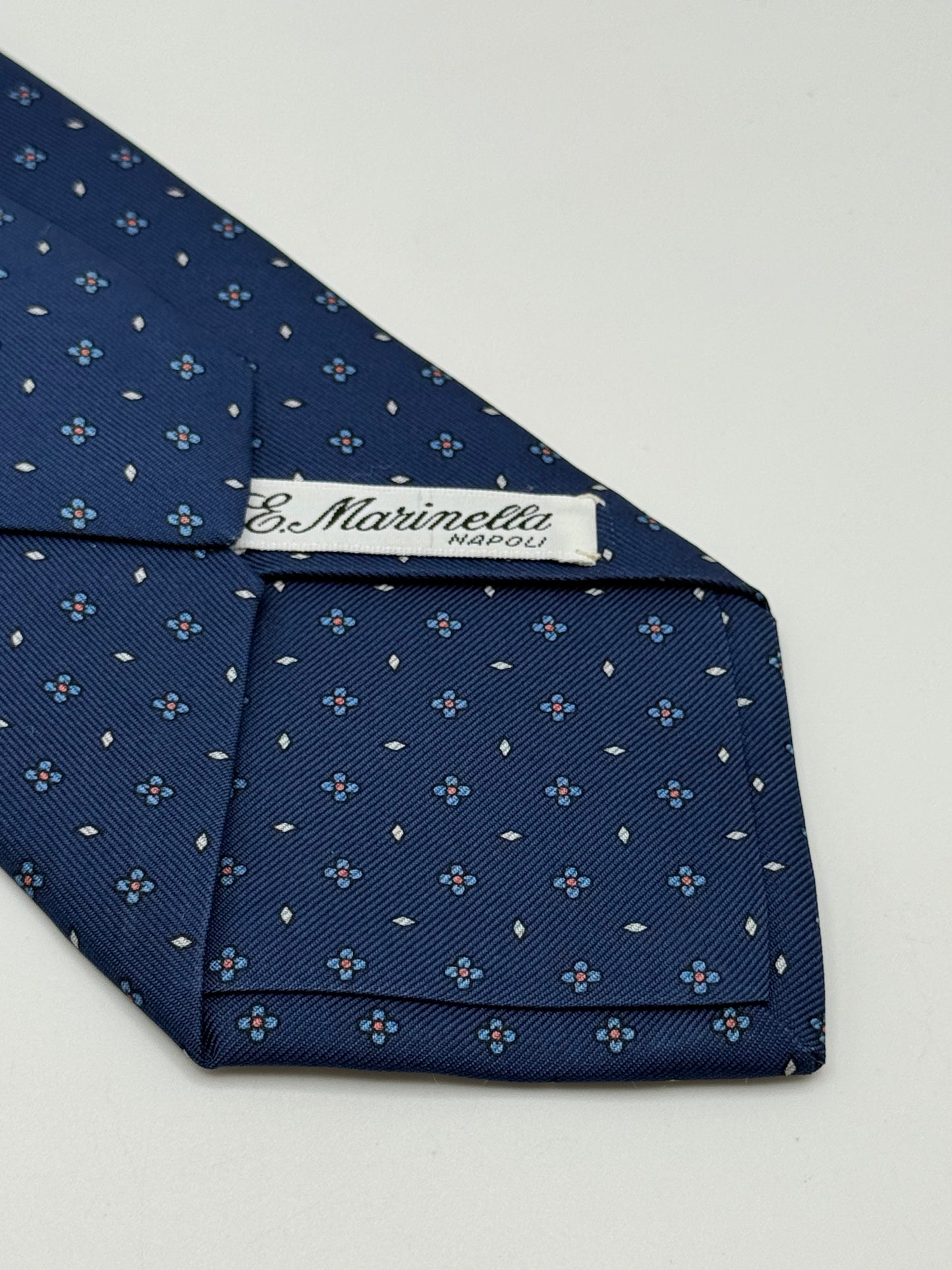 Dark blue twill silk tie whit small flower pattern