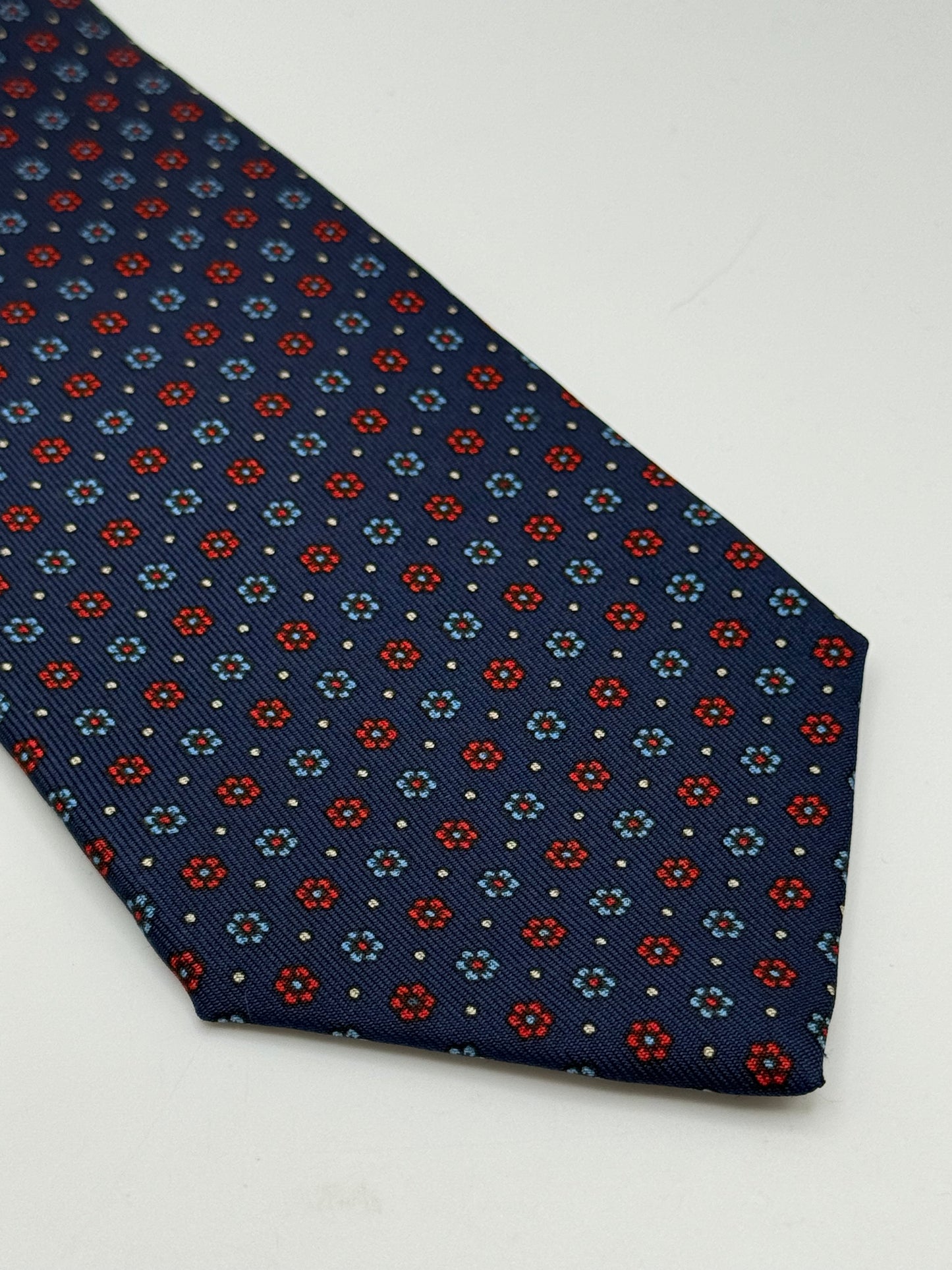 Dark blue twill silk tie whit small flower pattern