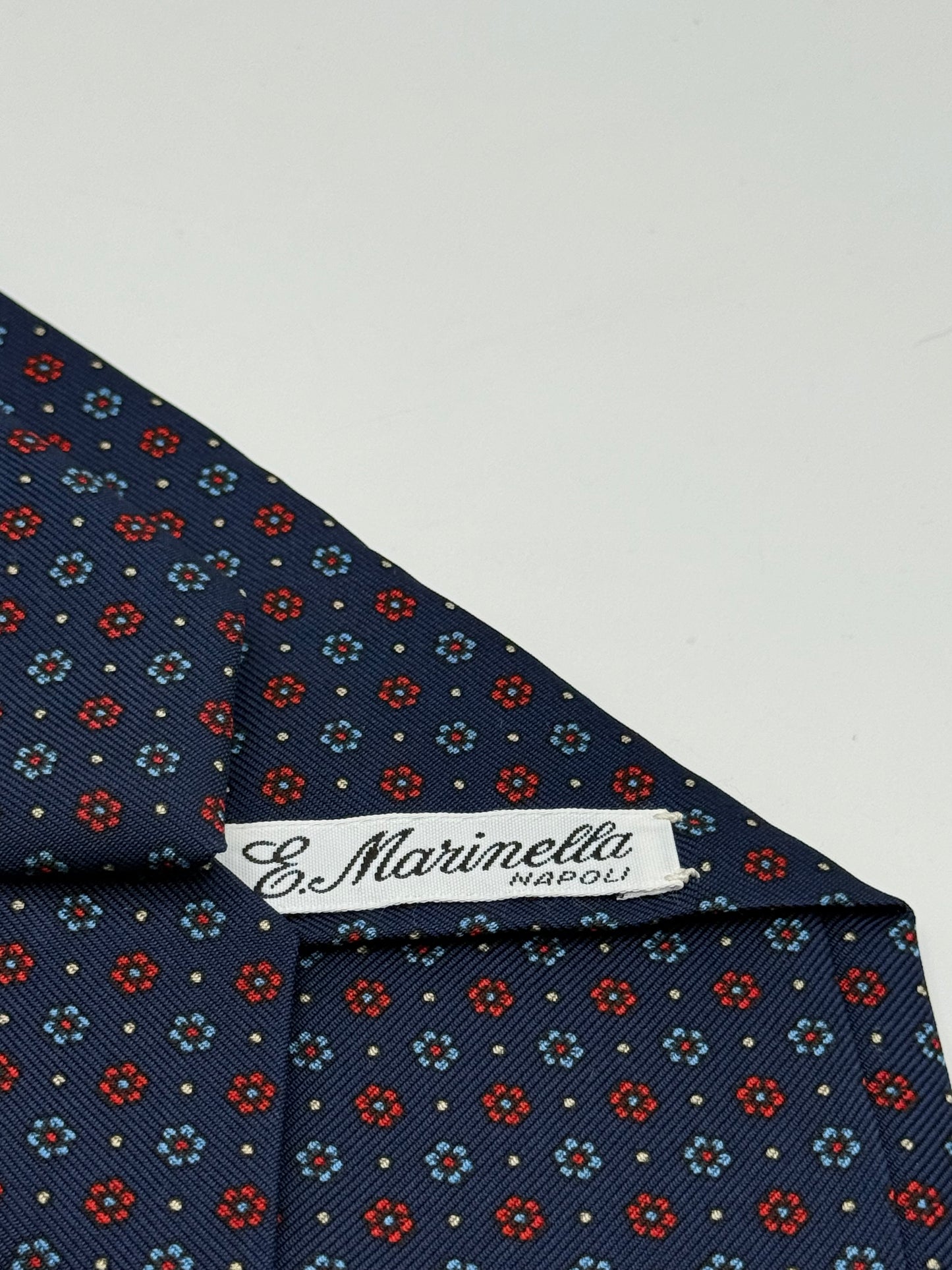 Dark blue twill silk tie whit small flower pattern